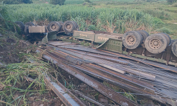 Tractor-trailer carrying steel overturns, two dead