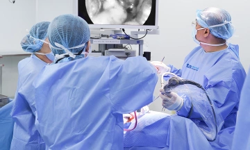 When should surgery for undescended testicles be performed on children?